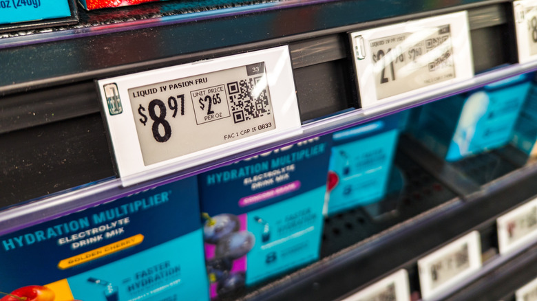 Digital tags on a set of Liquid IV nutritional supplements sit on a supermarket shelf