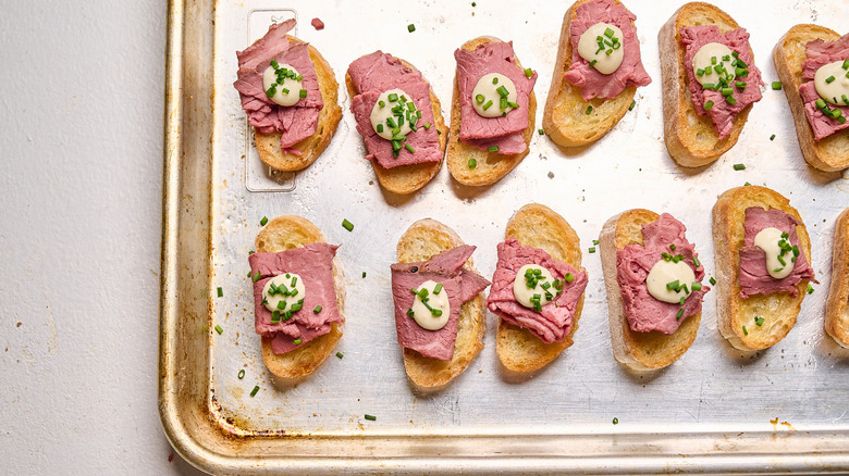 Beef crostini sprinkled with chives