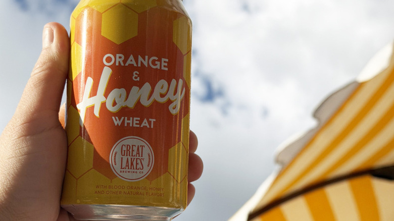 Hand holding a can of Great Lakes Brewing's Orange & Honey Wheat