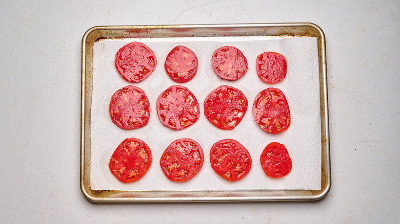salted tomatoes on a sheet tray