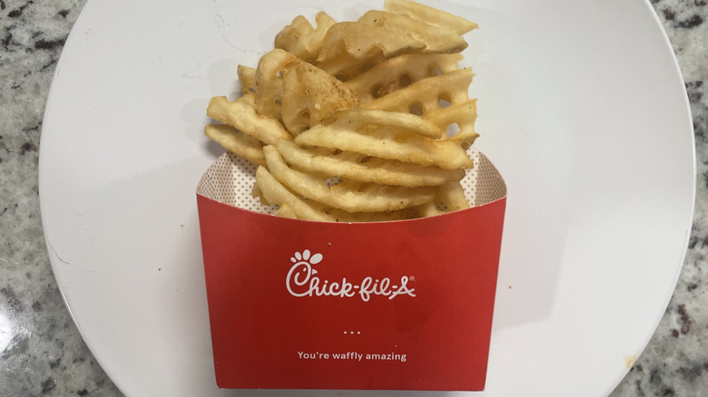 Chick-fil-A Waffle fries in a container and on a plate