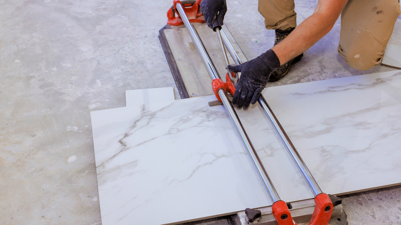 Worker cutting marble slab for kitchen