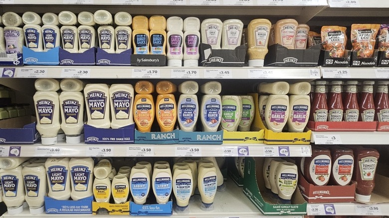 Supermarket shelves lined with Hellmann's and Heinz condiments