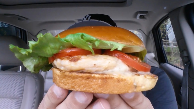 McDonald's artisan grilled chicken sandwich help by two hands