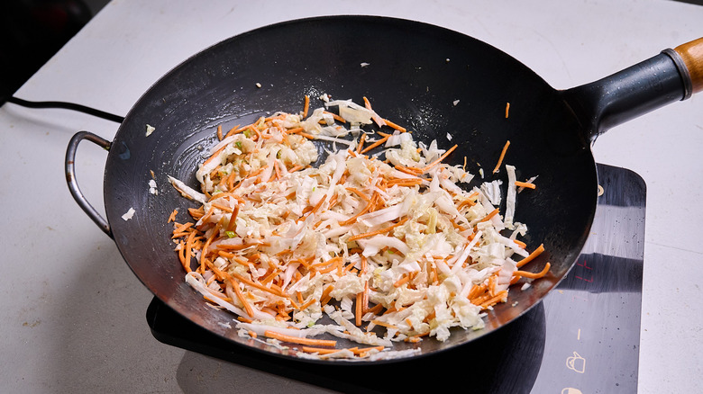 cooking vegetables in a wok