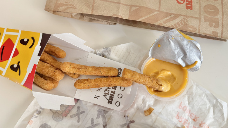 Burger King Game Day Chicken Fries with cheesy sauce on a table