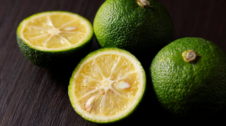 Sudachi fruit on wood cutting board