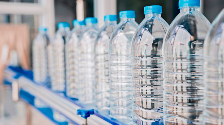 Line of plastic water bottles on conveyor belt