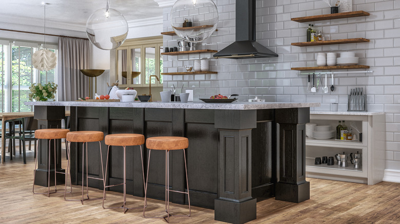 black kitchen with brown stools at island