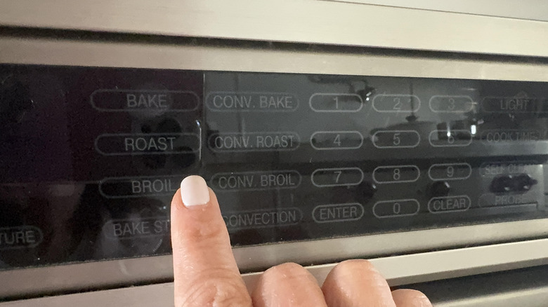 finger setting oven to broil