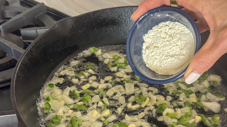 hand adding flour