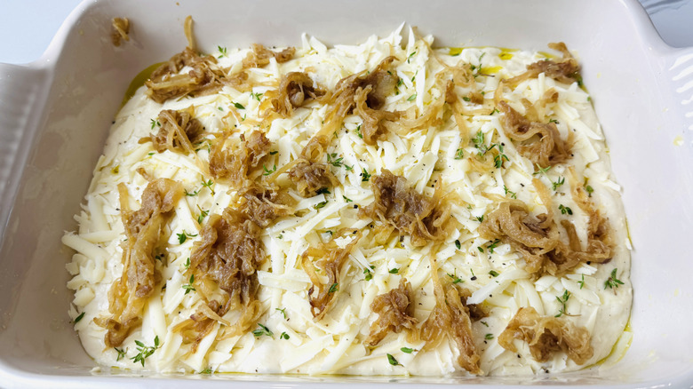 Focaccia dough topped with caramelized onions