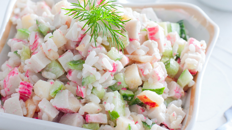 A cermaic dish piled with imitation crab salad