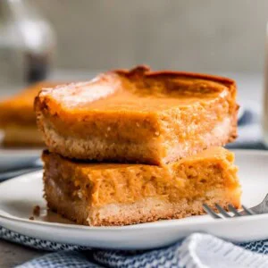 Pumpkin Gooey Butter Cake is a fall dessert recipe, but I like to make (and eat!) this ooey gooey cake year-round! If you don't know what gooey butter cake is, then you NEED to make this recipe ASAP. The combination of pumpkin and the gooey butter cake will blow your mind!