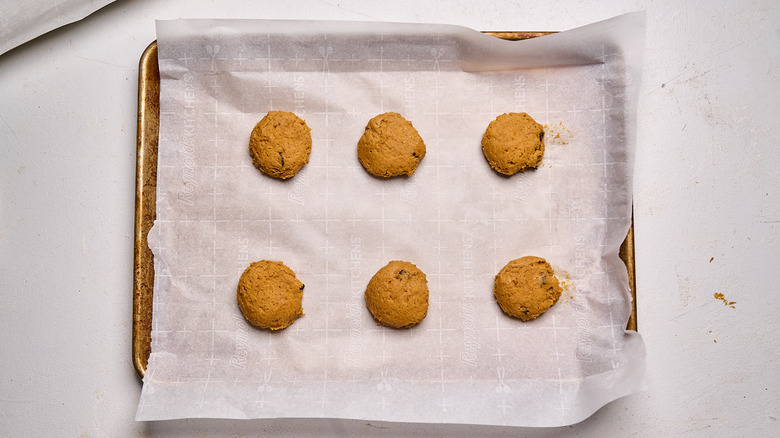 dough pressed into discs on a sheet tray
