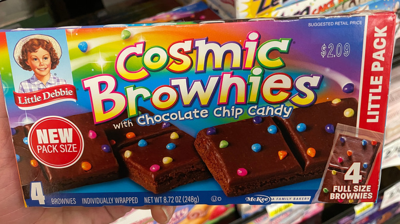 Hand holding of Little Debbie Cosmic Brownies at store