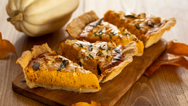 Slices of pumpkin pie with fried herbs and feta cheese on top.