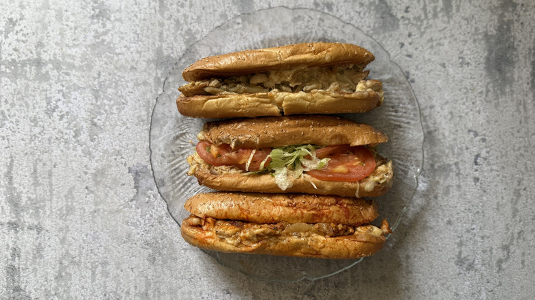 a plate of three Arby's Chicken Cheesesteaks