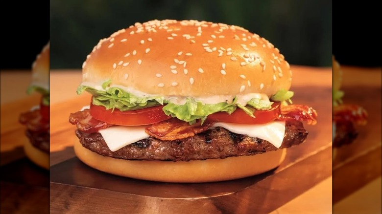 Burger King Peppercorn BLT Whopper burger on top of wooden board