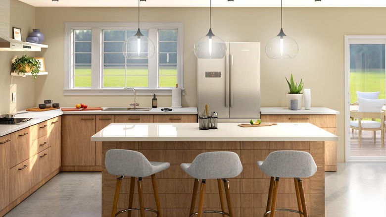 A kitchen scene with neutral colors and pendant lighting