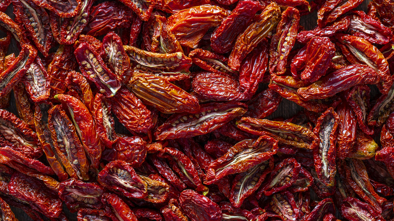 A close-up of lots of sun-dried tomato halves.