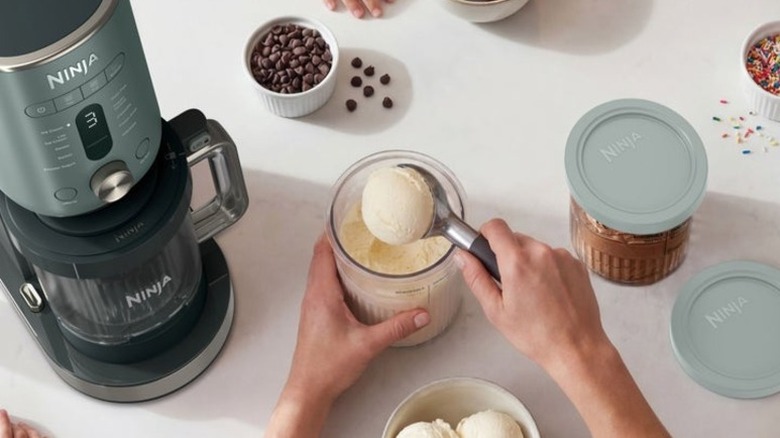 Person scooping vanilla ice cream from a Ninja XL tub