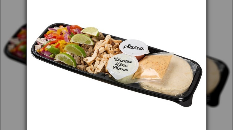 Kirkland Signature Beef and Chicken Fajita kit in deli container on a white background