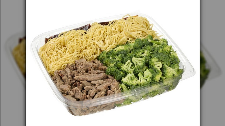 Kirkland Signature Beef and Broccoli with Noodles in a plastic deli container on a white background