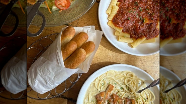 Assortment of Olive Garden food on a table.