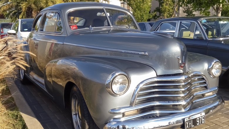 1948 Chevrolet parked next to another car on a sunny day