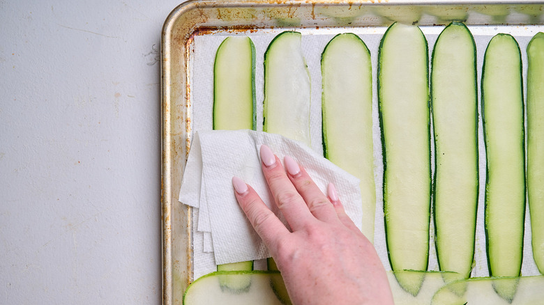 blotting zucchini dry with paper towel