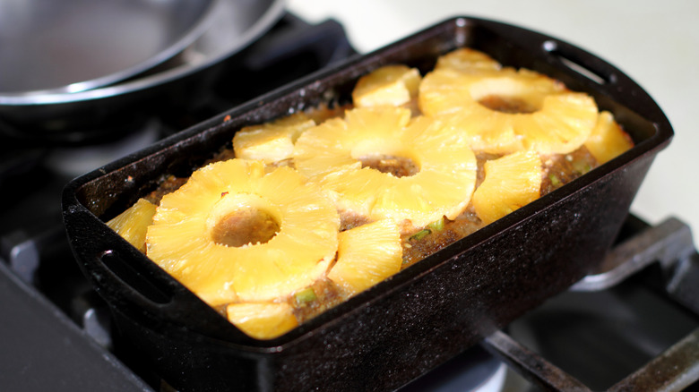 meatloaf topped with pineapple rings in a loaf tin