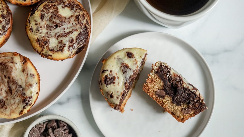 Cheesecake brookie muffin halved on plate