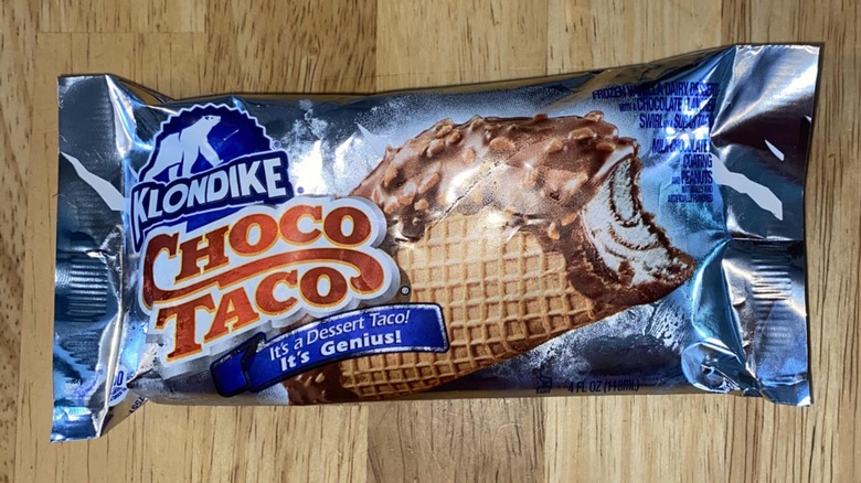 A Klondike Choco Taco displayed on a wooden table