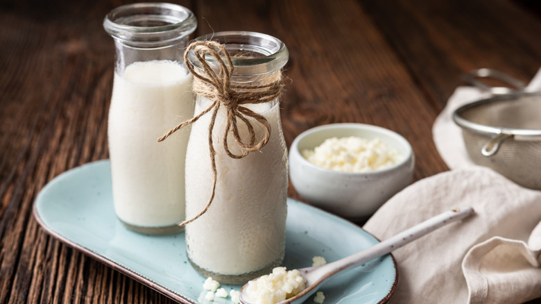 Kefir milk and kefir grains on a wooden table
