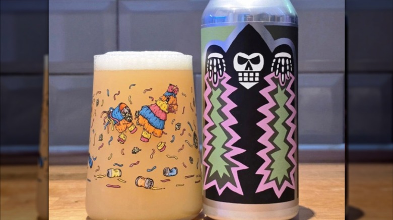 A can of Demorili 0028 beer featuring a cartoon reaper shooting pink and green lighting next to a full glass.