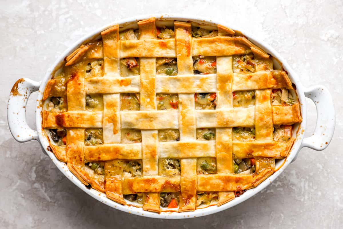 Egg wash being brushed on lattice crust before baking.