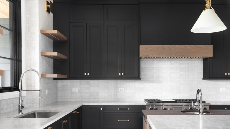 kitchen with black cabinets and granite counter tops