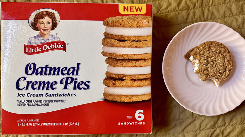 Box of Little Debbie Oatmeal Creme Pies with pink plate