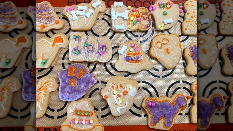 A tray of decorated Halloween sugar cookies using a Walmart cookie kit