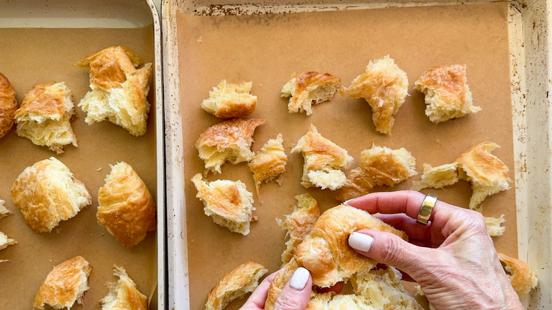 hands tearing the croissants