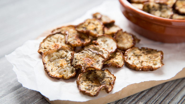 Eggplant chips on piece of white parchment paper