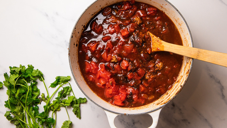 mole turkey chile cooking in Dutch oven
