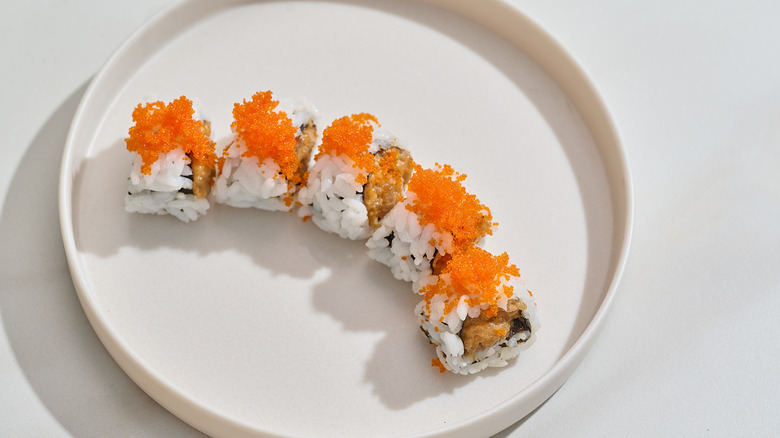 sushi topped with fish roe on table