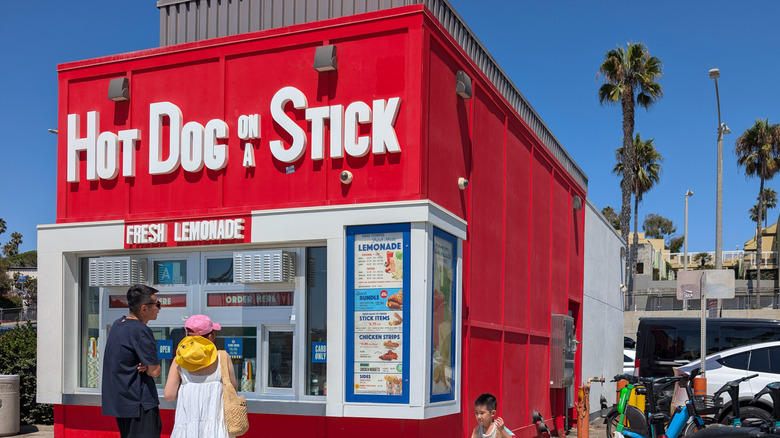 A red shack that says Hot Dog on a Stick
