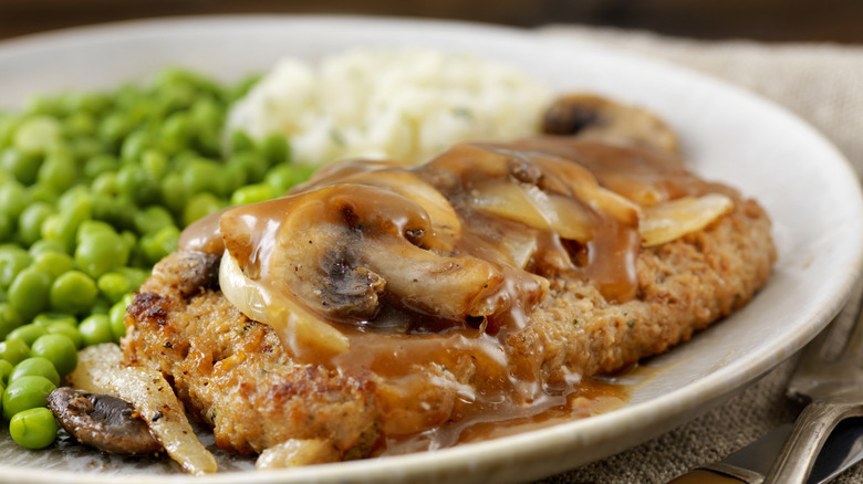 Salisbury steak with mushrooms, peas, and gravy