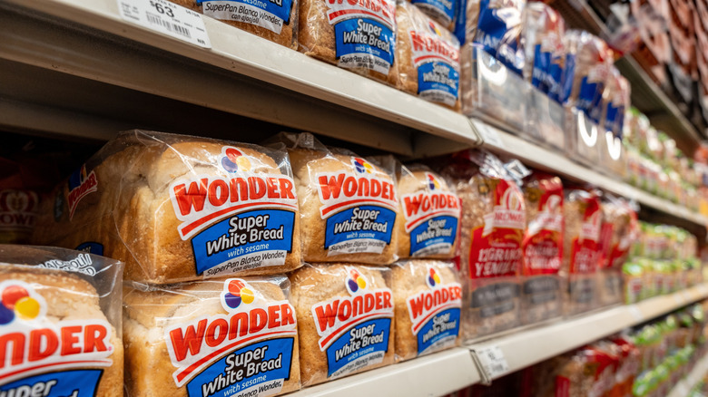 Supermarket shelves with loaves of bread