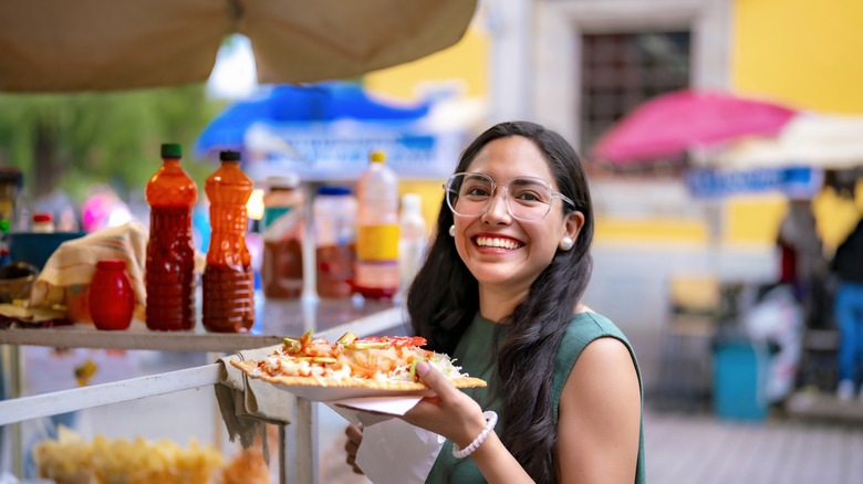 Confident tourist enjoying Mexican street food