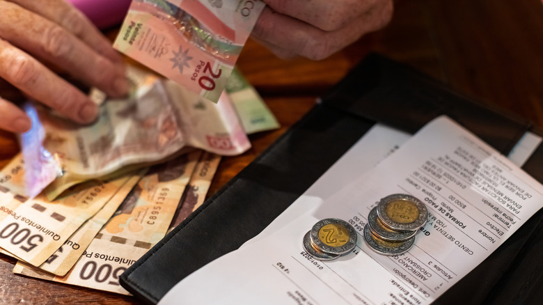Paying a restaurant bill with pesos in Mexico