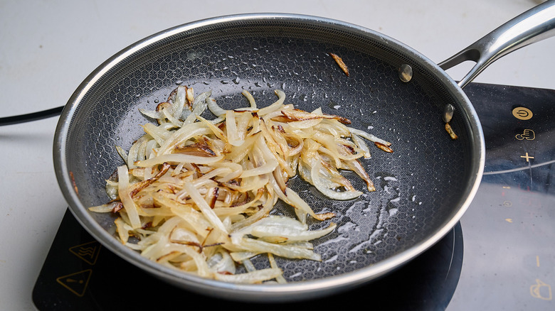 cooking onions in a skillet